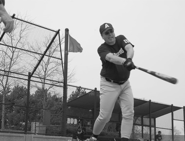 Adjusters outfielder John Toth, N.21, hits ground balls to infielders at an early practice session on Eakin Fields. (Photo by Chris LaPelusa/Sun Day)