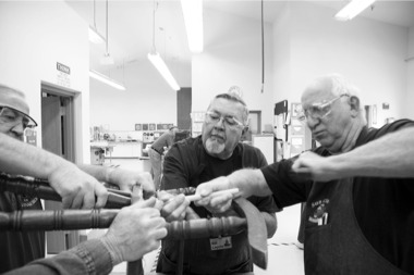 (Left to right) Woodchucks members Bob Duke, N.17, Bill Lepola, N.15, and Jim Barron, N.4, repair an old rocker at the Ask the Woodchucks event. (Photo by Chris LaPelusa/Sun Day)