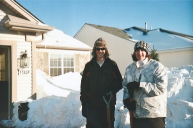 Huntley High School juniors Drew Westermeyer (left) and Harry Choin shovel snow off a Sun City residents driveway this winter. (Photo provided)