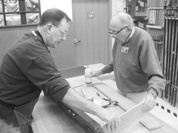 Fred Teeman and Bob Janninck assemble a dresser drawer.