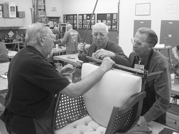 Bill Lepola, Jim Barron, and Jerry Jarvis consult on the best way to repair a chair. (Photos provided)