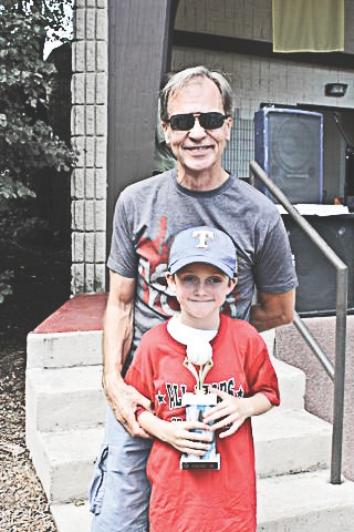 Cam Wiehe stands with his grandfather Bob Wiehe behind him. (Photo provided)