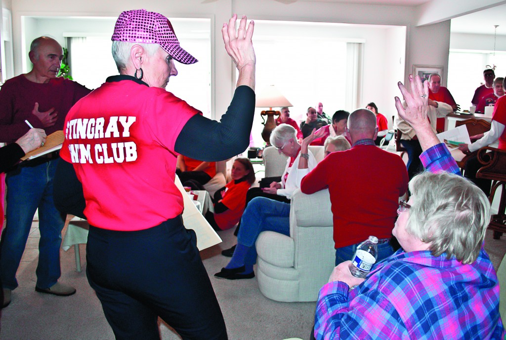 Joanie (front) and Nick Koplos (left, back) lead participants through the auction held during the Stingray’s Feb. 8 Valentine’s Day Party. (Victoria Diamond I Sun Day Photo)