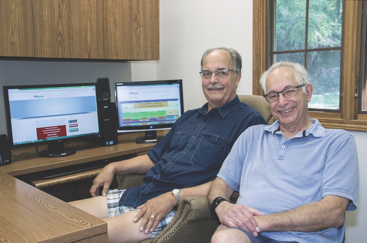 Dave Eggers (left) assumes the role of Huntley Community Radio Executive Director as HCR creator Allen Pollack steps down. They’re posed here in an HCR office. (Photo by Tony Pratt/Sun Day)