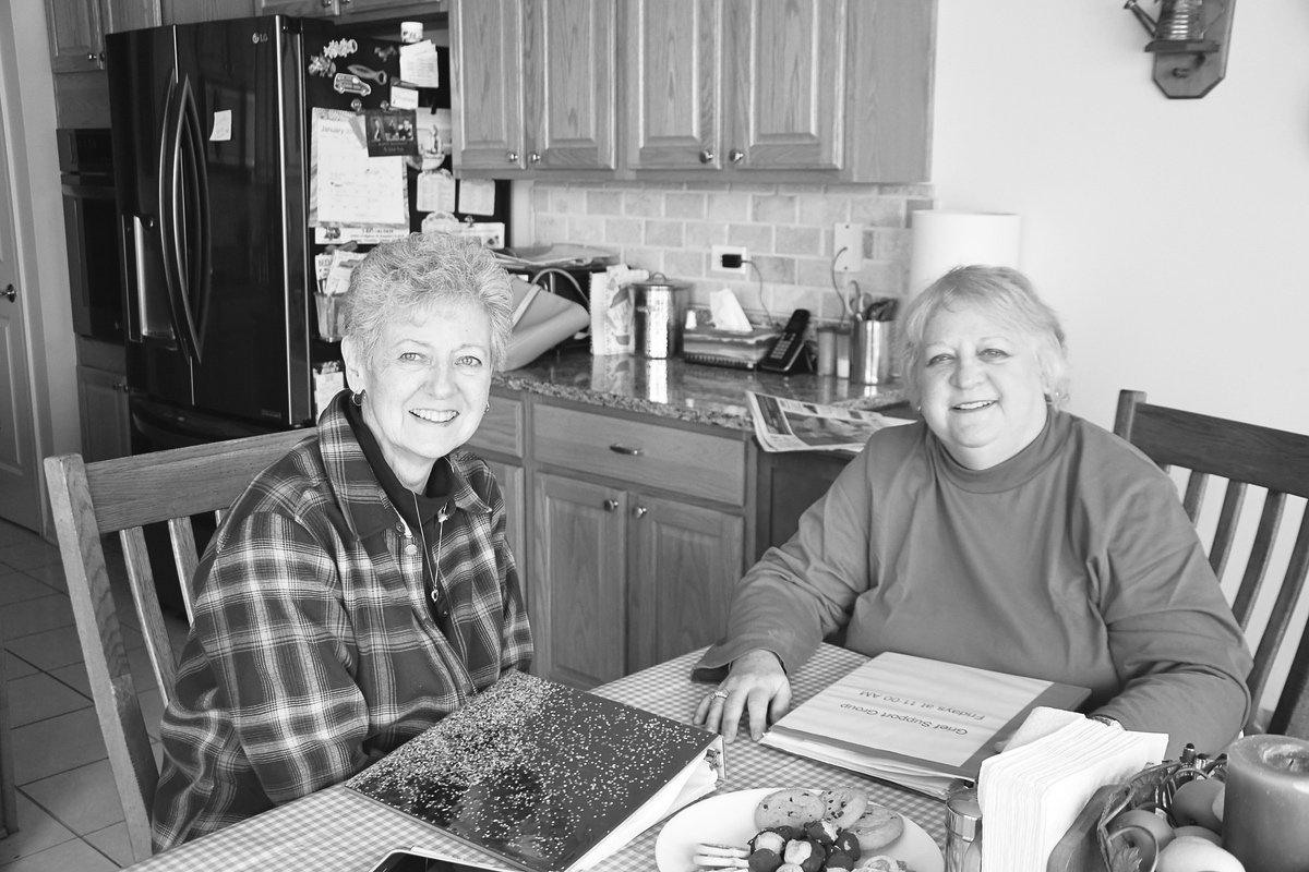 Pat Henning (left) and Sharon Stevens discuss the Bridges to Recovery. (Photo by Christine Such/Sun Day)