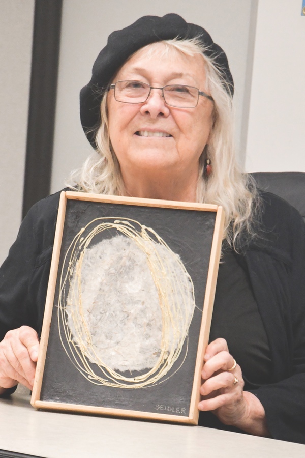 Artist Nancy Seidres with her donated piece for Empty Bowls. (Photo by Christine Such/Sun Day)