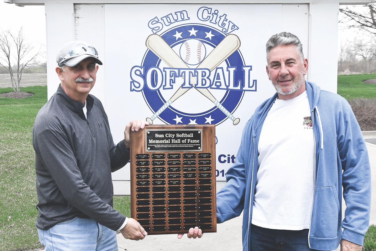 John Roccosanto, Suncity Softball Board Member (left) and Chuck Hund Softball Club President hold Plaque to Honor deceased members. (Photo by Christine Such/Sun Day)