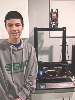 Sloan with his 3D printer. (Photo provided)