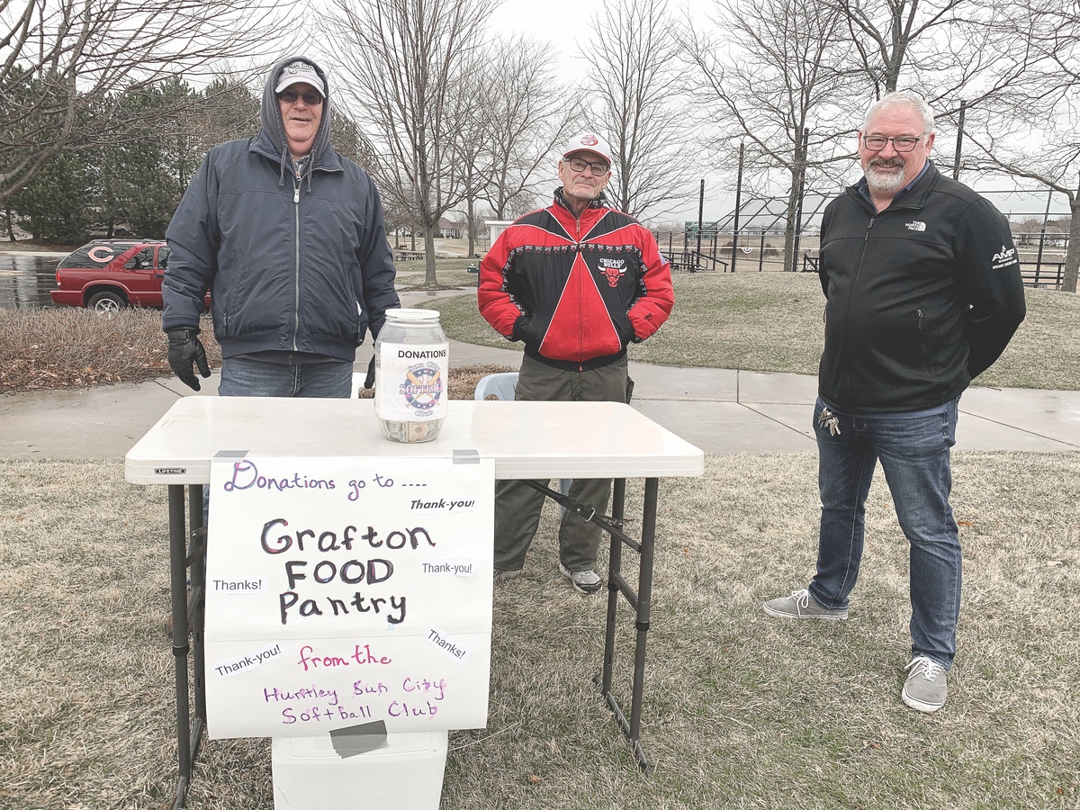 Softball Club sets up collection table for much-needed Food Pantry donations. Featured here are softball club members (L to R) Bill Klinger and Eddie Fabro with Grafton Food Pantry President Jim Drendel. (Photo provided)