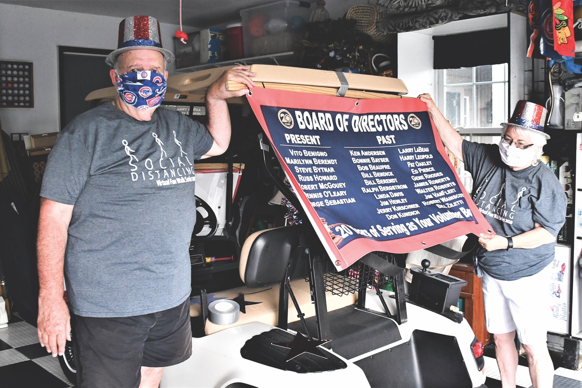 Marilynn and Bill Berendt decorating their cart in PPEs. (Photos by Christine Such/Sun Day)