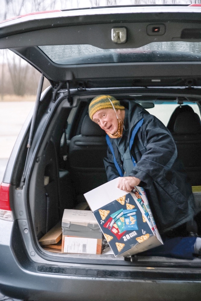 Rich Escallier unloads a van stocked with toys.