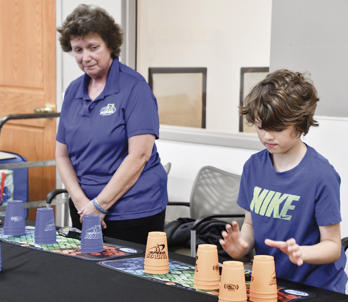 Deb Randazzo, Field Instructor for Speedstacks in Illinois, gets ready to race 9-year-old Kaden Castor. (Photo by Christine Such/My Sun Day News)