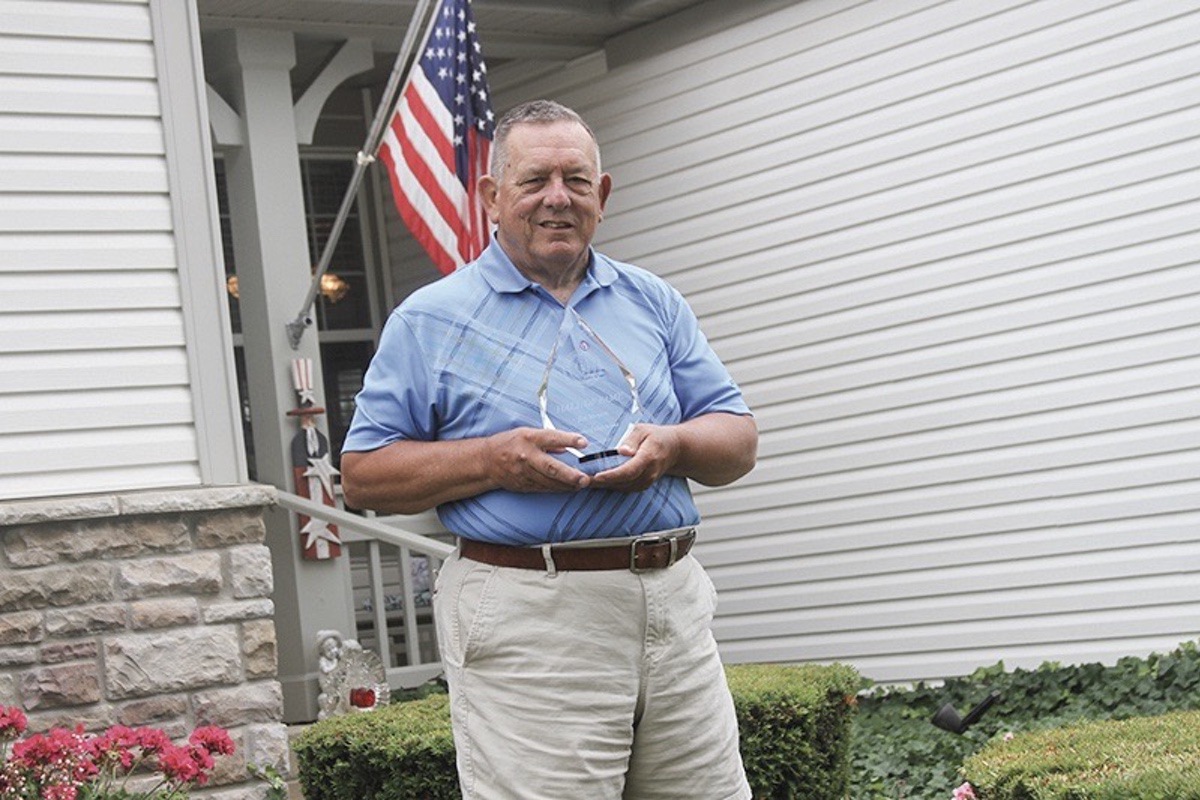 Jim Meyers of Sun City, a retired high school athletic director, shows his Hall of Fame Plaque he received from the Illinois Athletic Director’s Association. p(Photo by Steve Peterson/My Huntley News)