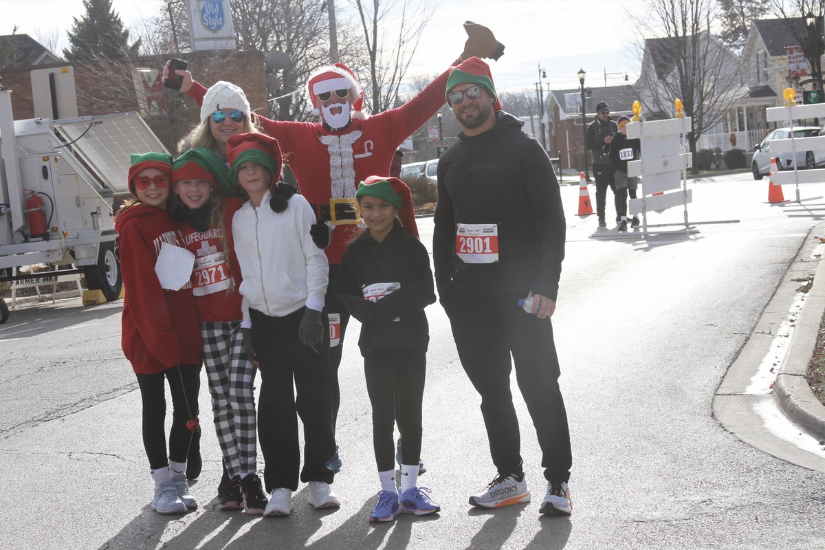 Runners are happy to complete the Rotary Club of Huntley’s Run With the Elves. The event was part of Very Merry Huntley Dec. 7. Front row from left: Evelyn Jones, Shaya Speten, Alyssa Armstrong, and Aria Armstrong. Back row: Tami Speten, Shane Speten, and Phillip Armstrong. p(Photo by Steve Peterson/My Sun Day News)